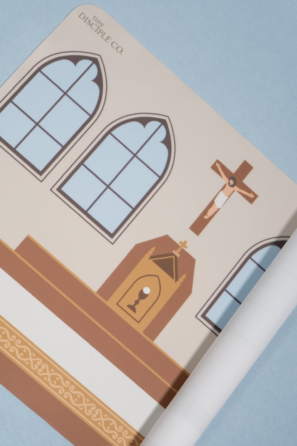 A close-up of a silicone mat faturing a stylized illustration of a church interior with arched windows, an altar, and a crucifix. The text 'THE DISCIPLINE CO.